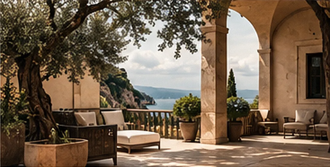 A stone terrace under an olive tree, looking out to the sea